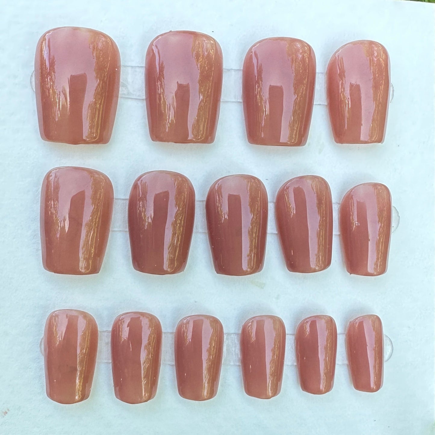 set of press on nail dark brown color have 30 pcs in the set. and 2 shapes to order square and almond. samples on a white card with grass in the background